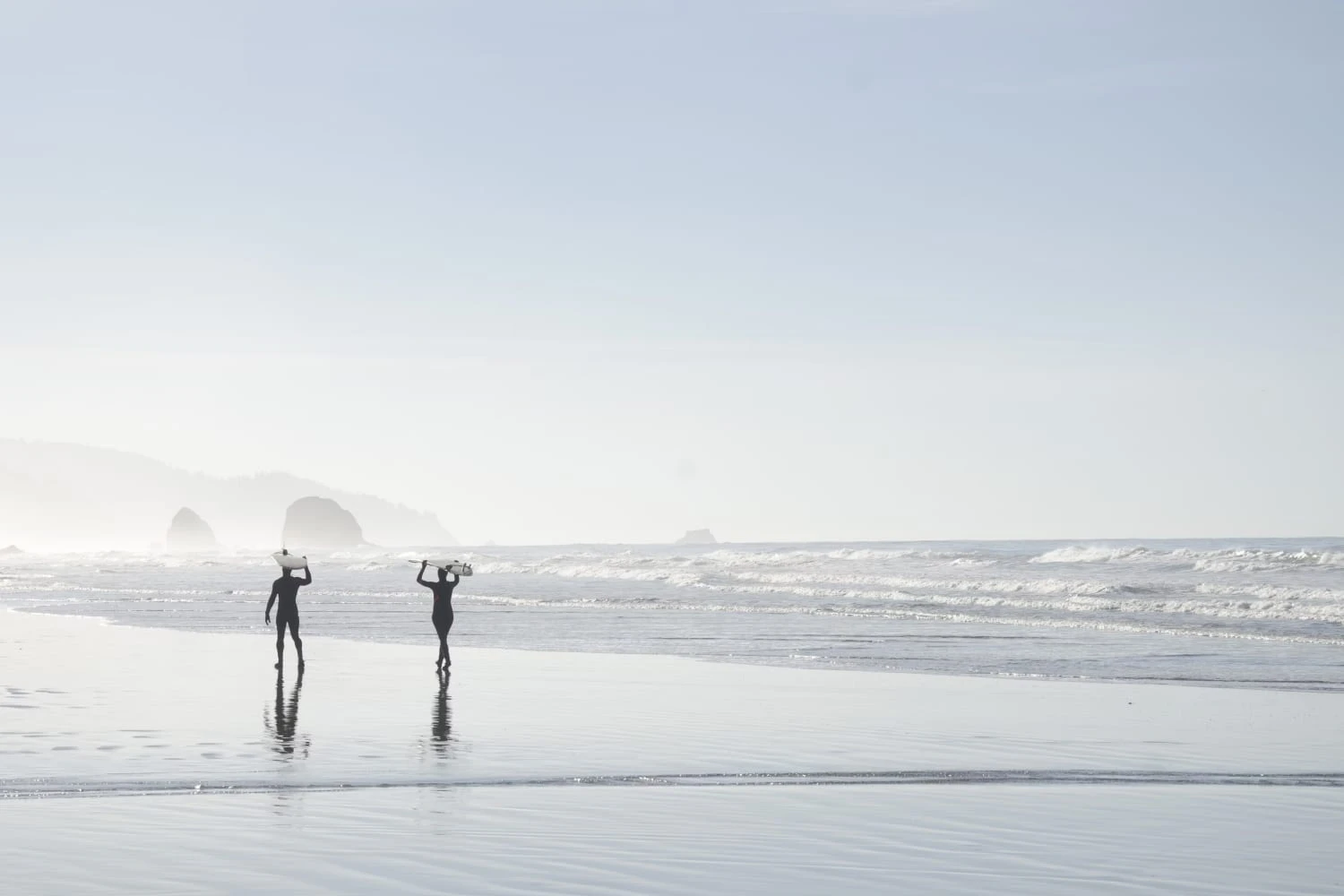 Surfer silhouettes on Cannon Beach