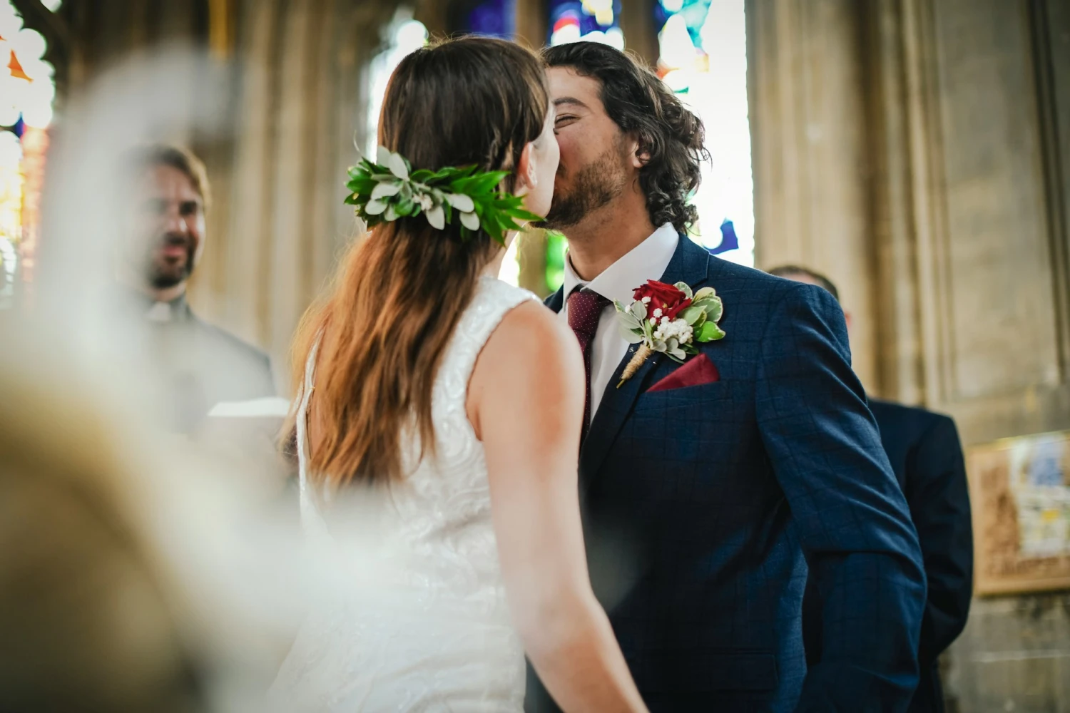 A newly married couple having their bridal kiss moment at the altar