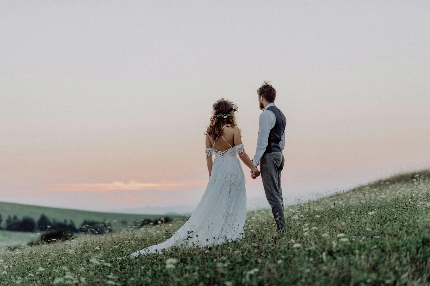 A newlywed couple looking out over a field of flowers