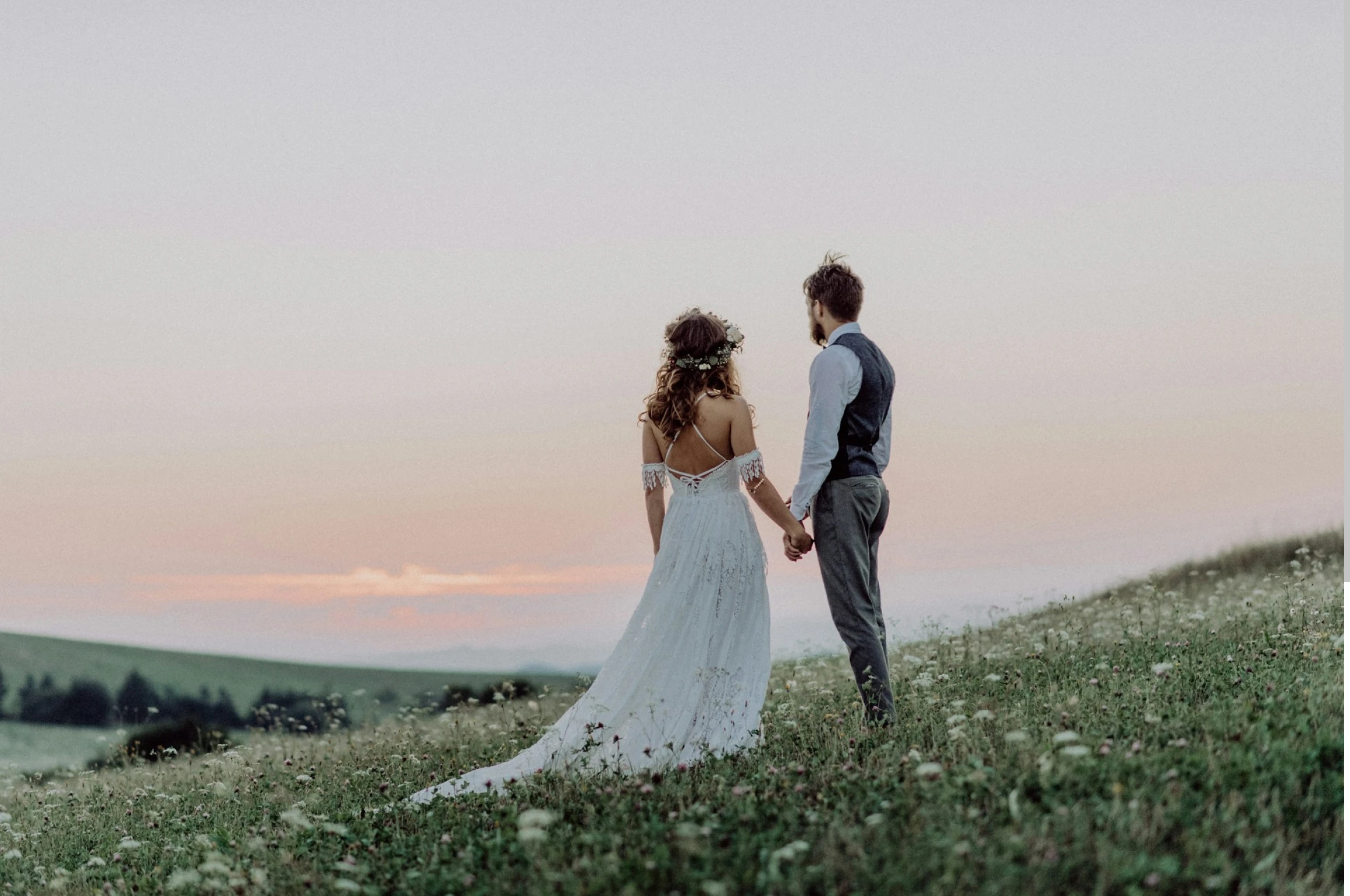 A newlywed couple looking out over a field of flowers