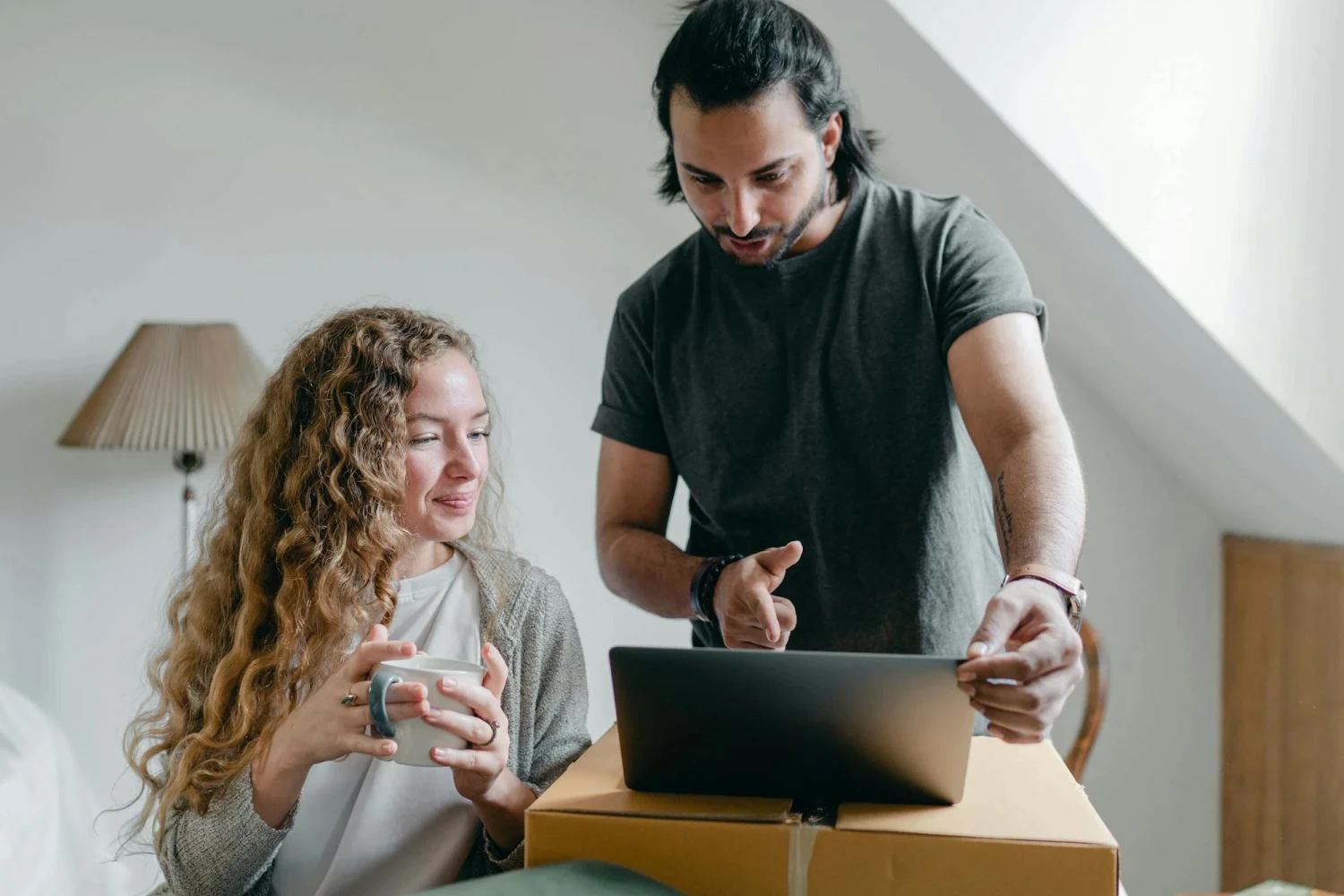 A man and woman planning their digital wedding on a device