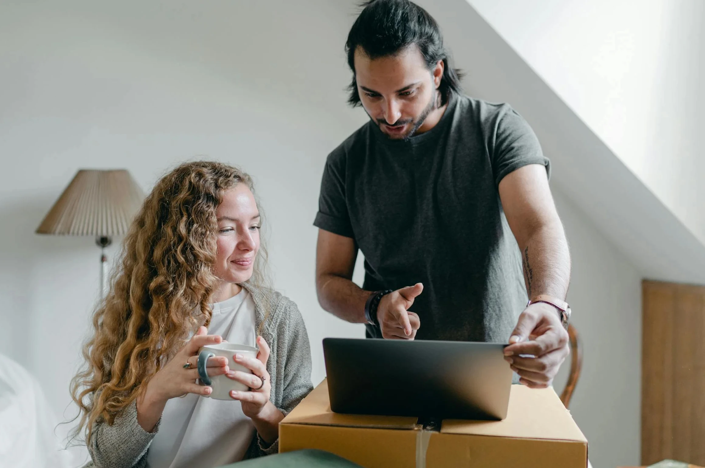 A man and woman planning their digital wedding on a device